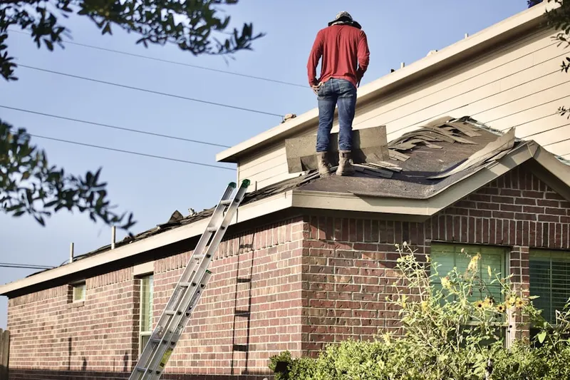 Professional roofer working on a residential roof in Bel Pre Farms